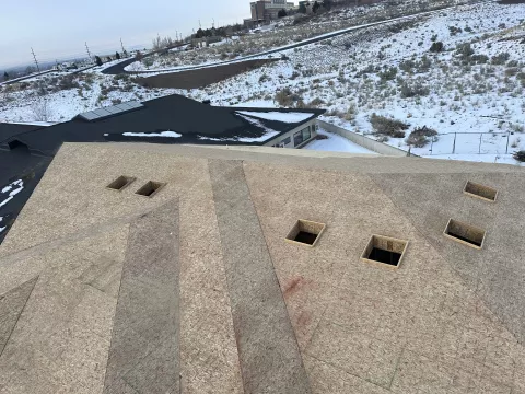 BLU-D Framing aerial view of fully sheathed hip roof lines with skylights cut on Pocatello Children's Clinic