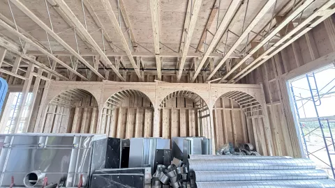 Head on view of 4 timber framed archways over booth area. 