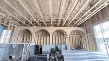 Head on view of 4 timber framed archways over booth area. 